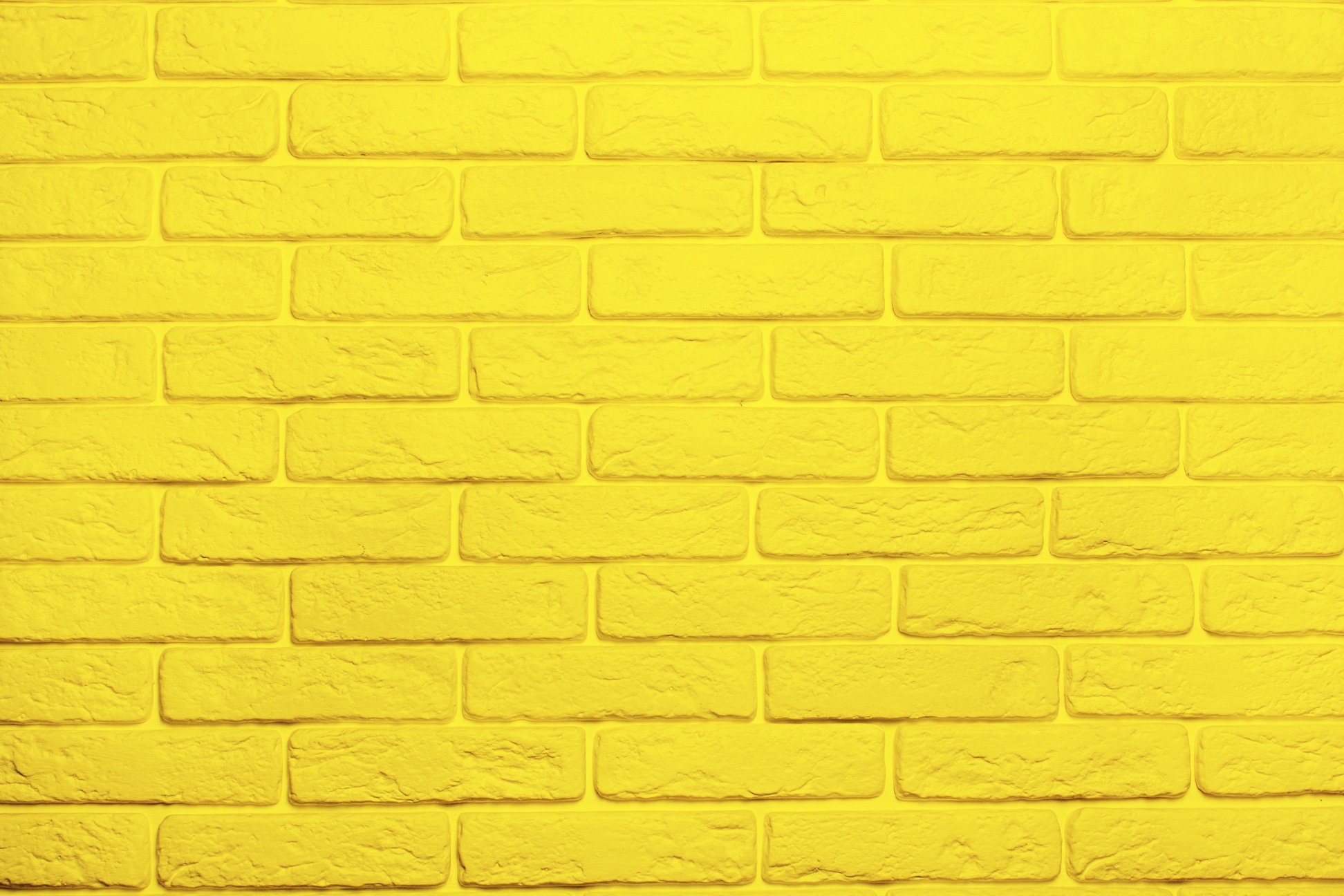 Yellow brick wall background. Trend color 2021 yellow